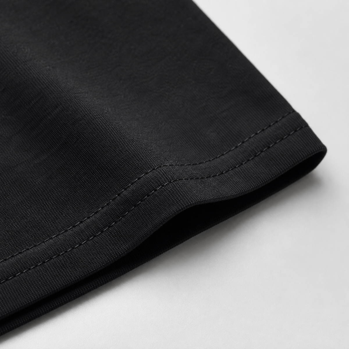 Black double-stitched hem close-up